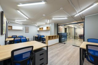 Contemporary office with glass doors and new furniture